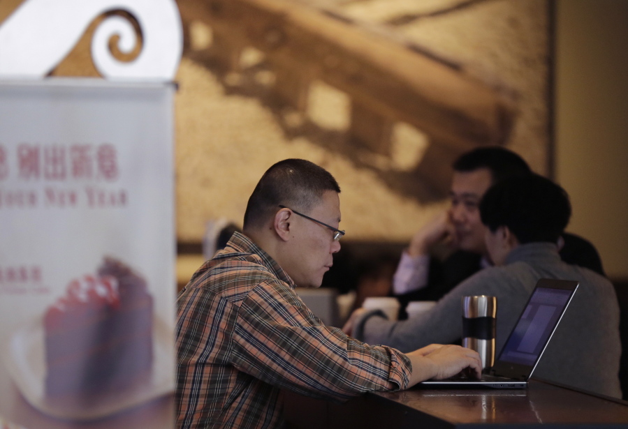 A man surfs Internet on his laptop computer at a Starbuck cafe in Beijing. Security researcher say China’s fondness for pirated software left it especially vulnerable to the latest global cyberattack.