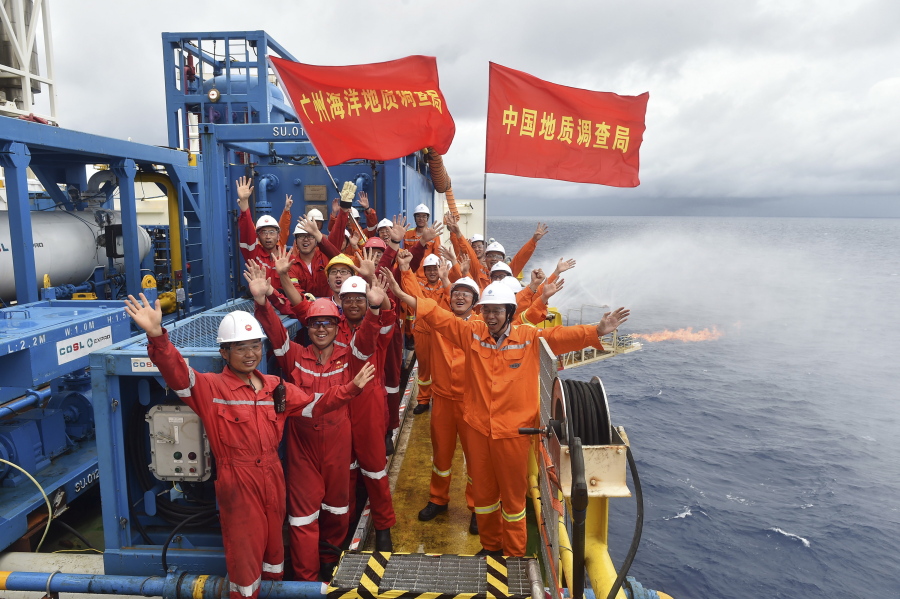Workers celebrate May 16, 2017, the successful trial extraction of natural gas from combustible ice trapped under the seafloor on a drilling platform on the South China Sea. Commercial development of the globe’s vast reserves of a frozen fossil fuel known as combustible ice has moved closer to reality after Japan and China successfully extracted the material from the seafloor.