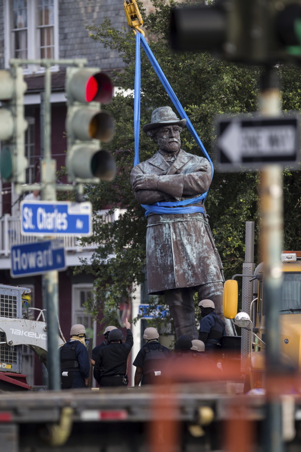 A statue of Confederate General Robert E. Lee is lowered to a truck for removal Friday, May 19, 2017, from Lee Circle in New Orleans. The city council to remove the monument and three other Confederate and white supremacist monuments in Dec. 2015. An obelisk honoring the militia known as the White League was taken down in April; a statue of Confederate President Jefferson Davis was removed May 11; and a statue of Confederate General P.G.T. Beauregard was taken down on Wednesday.