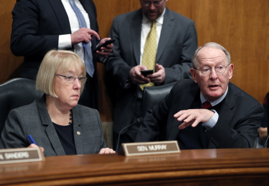 Senate Health, Education, Labor, and Pensions Committee Chairman Sen. Lamar Alexander, R-Tenn., accompanied by the committee’s ranking member Sen. Patty Murray, D-Wash. speaks Jan. 31 on Capitol Hill in Washington. In closed-door meetings, Senate Republicans are trying to write legislation dismantling President Barack Obama’s health care law. They would substitute their own tax credits, ease coverage requirements and cut the federal-state Medicaid program for the poor and disabled that Obama enlarged.