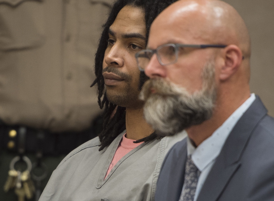 Robert Grott, left, appears for a sentencing hearing at the Pierce County District Courthouse in Tacoma Friday. Grott, 31, has been sentenced to 50 years in prison for killing a man he knew in a hail of bullets at a Tacoma gas station.