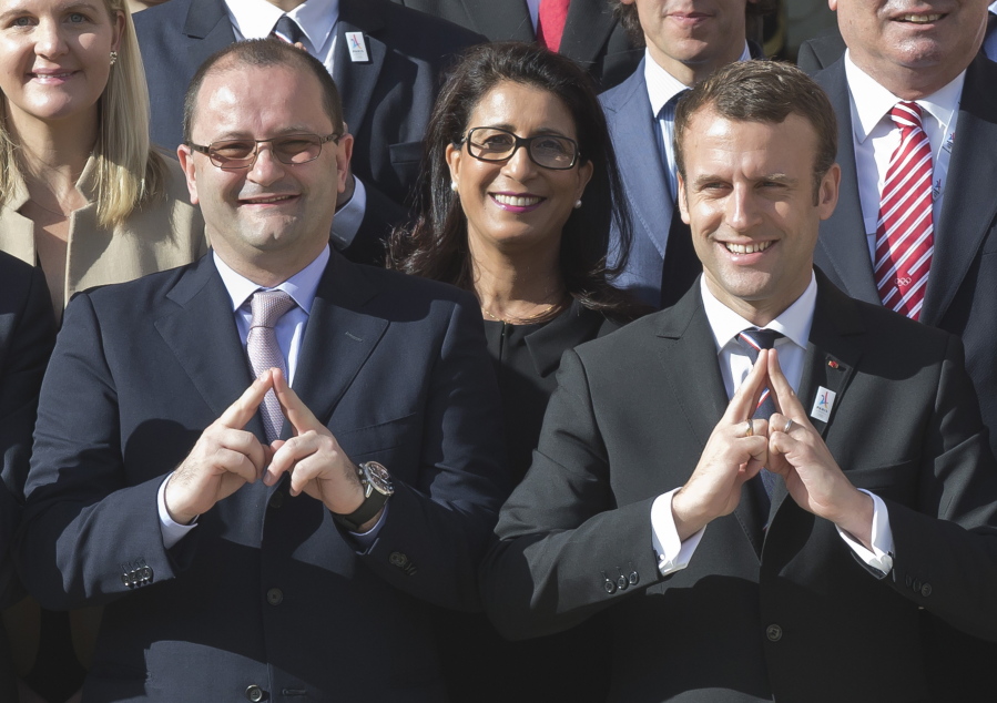 International Olympic Committee Evaluation Commission Chair Patrick Baumann, left, and new French President Emmanuel Macron make a singe representing the logo of Paris 2024 bid as they pose during a group photo at the Elysee palace in Paris, France, on May 16. France’s new President Emmanuel Macron is hosting the International Olympic Committee to try to boost Paris’ bid to beat out Los Angeles in the heated race for the 2024 Games.