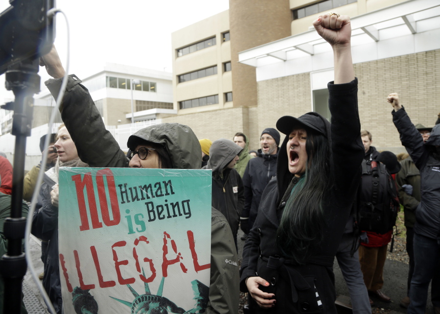 Protesters chant during a February immigration rally in Portland. A bill filed Wednesday would prohibit public bodies in Oregon from sharing information about a person’s immigration status except when required by law.