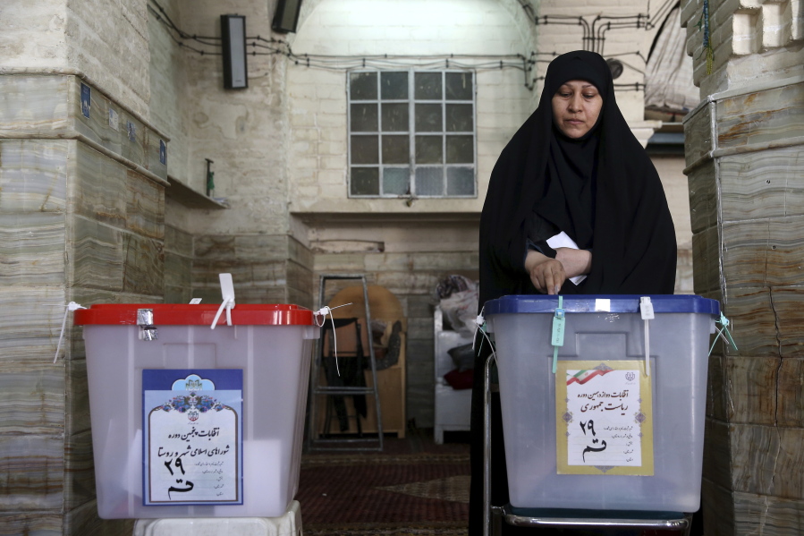 An Iranian voter casts her ballot Friday during the presidential and municipal council election at a polling station in the city of Qom, 78 miles south of the capital Tehran, Iran. Iranians began voting Friday in the country’s first presidential election since its nuclear deal with world powers, as incumbent Hassan Rouhani faced a staunch challenge from a hard-line opponent over his outreach to the wider world.