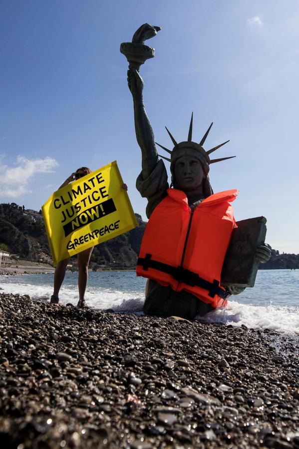 Greenpeace activists stage a demonstration in Giardini Naxos, near the venue of the G7 summit in the Sicilian town of Taormina, southern Italy, on Friday. Climate change promises to be the most problematic issue for this summit after Trump’s decision to review U.S. policies related to the Paris Agreement on fighting global warming.