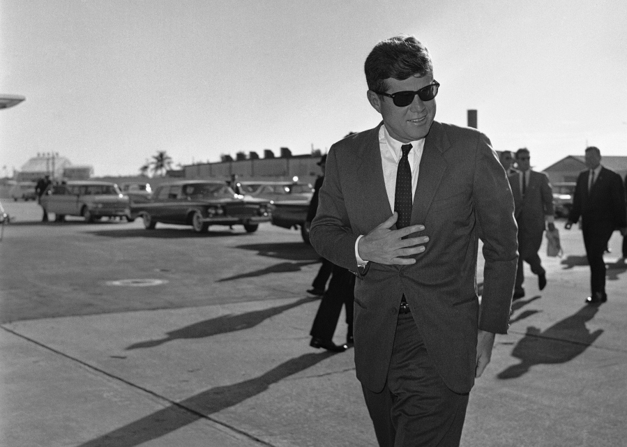 In this Dec. 18, 1961 file photo, President John F. Kennedy heads for Washington after an overnight stopover in West Palm Beach, Fla., where he rested after his Latin American tour due to a heavy cold.