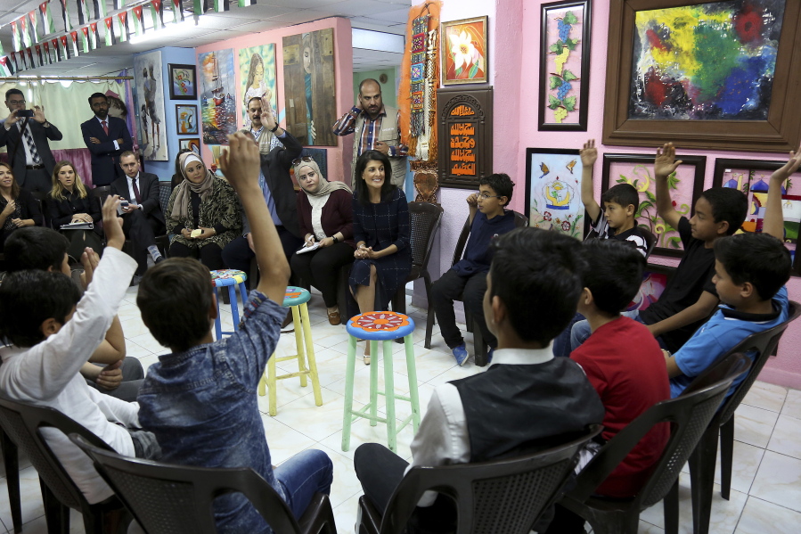 Nikki Haley, center, American ambassador to the United Nations, meets with Iraqi and Syrian refugees Monday in an after-school program partially funded by the U.S. in Amman, Jordan. Haley is pledging additional support for refugees fleeing Syria’s long civil war.