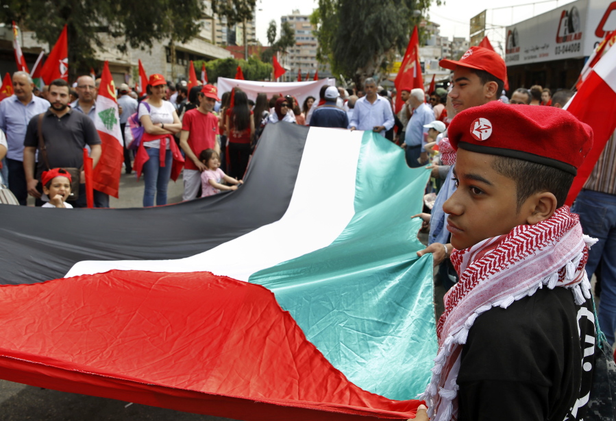 Bilal Hussein/Associated Press
People carry a Palestinian flag during a rally in Beirut, Lebanon, May 1.