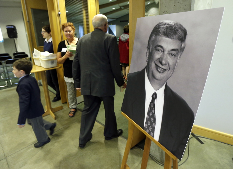 A photo of former Washington Gov. Mike Lowry is displayed at his memorial service Tuesday in Renton.