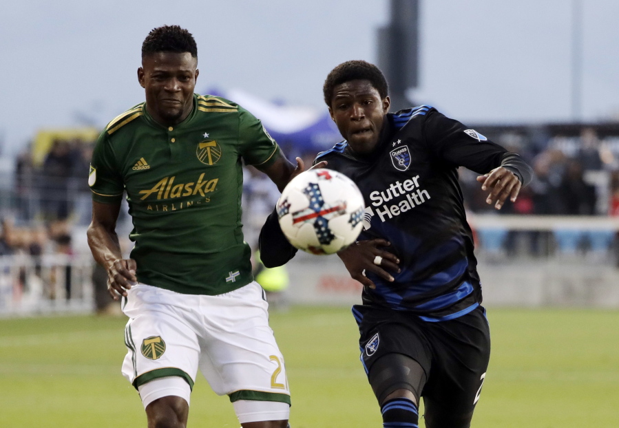 Portland Timbers forward Dairon Asprilla, left, eyes the ball as San Jose Earthquakes defender Kofi Sarkodie, right, chases during the first half of an MLS soccer match, Saturday, May 6, 2017, in San Jose, Calif.