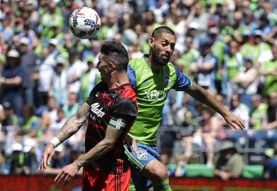 Seattle Sounders' Clint Dempsey, right, and Portland Timbers defender Liam Ridgewell, left, battle for a header in the second half of an MLS soccer match, Saturday, May 27, 2017, in Seattle. The Sounders won 1-0. (AP Photo/Ted S.
