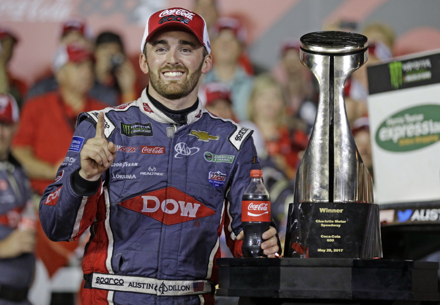 Austin Dillon poses with the trophy after winning the Coca-Cola 600 at Charlotte Motor Speedway.