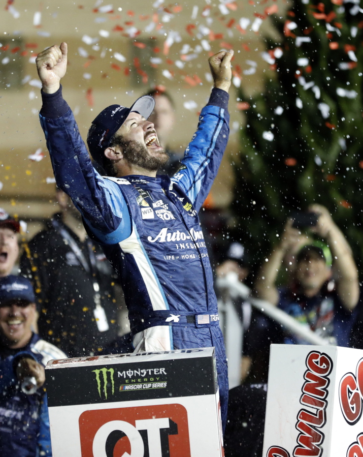 Martin Truex Jr. celebrates in Victory Lane after winning the NASCAR Monster Cup auto race at Kansas Speedway in Kansas City, Kan., Saturday, May 13, 2017. (AP Photo/Colin E.