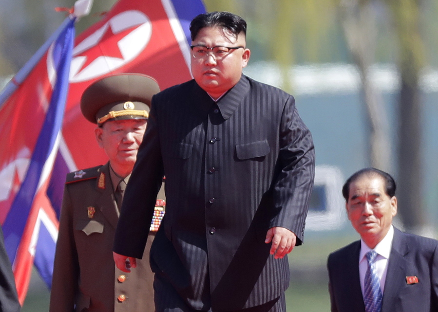 North Korean leader Kim Jong Un, center, is accompanied by Pak Pong Ju, right, Hwang Pyong So, second left, as he arrives April 13 for the official opening of the Ryomyong residential area, in Pyongyang, North Korea.