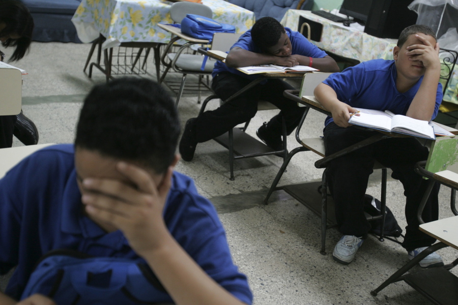 Students sit at their desks inside a classroom Jan. 24, 2008, at Republica del Peru middle school, in San Juan, Puerto Rico. The U.S. territory is closing 184 public schools, officials announced Friday, May 5, 2017, in a move expected to save millions of dollars amid a deep economic crisis.