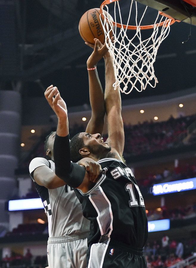 San Antonio Spurs forward LaMarcus Aldridge, right, shoots as Houston Rockets center Clint Capela defends during the second half in Game 6 of an NBA basketball second-round playoff series, Thursday, May 11, 2017, in Houston. San Antonio won 114-75.