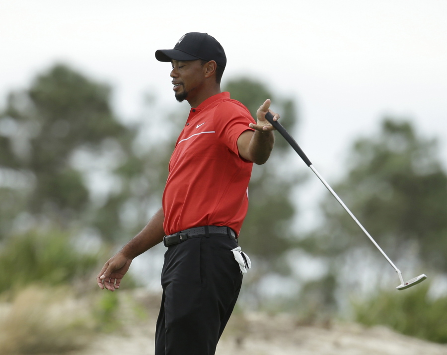 Tiger Woods reacts after a putt during the final round at the Hero World Challenge golf tournament, in Nassau, Bahamas.