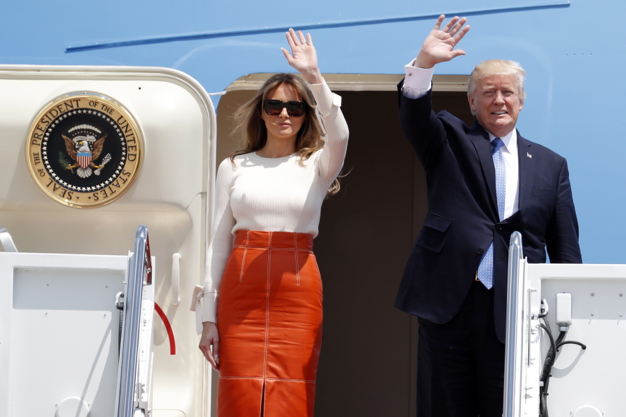 President Donald Trump and first lady Melania Trump, wave as they board Air Force One at Andrews Air Force Base, Md., Friday, May 19, 2017, prior to his departure on his first overseas trip.