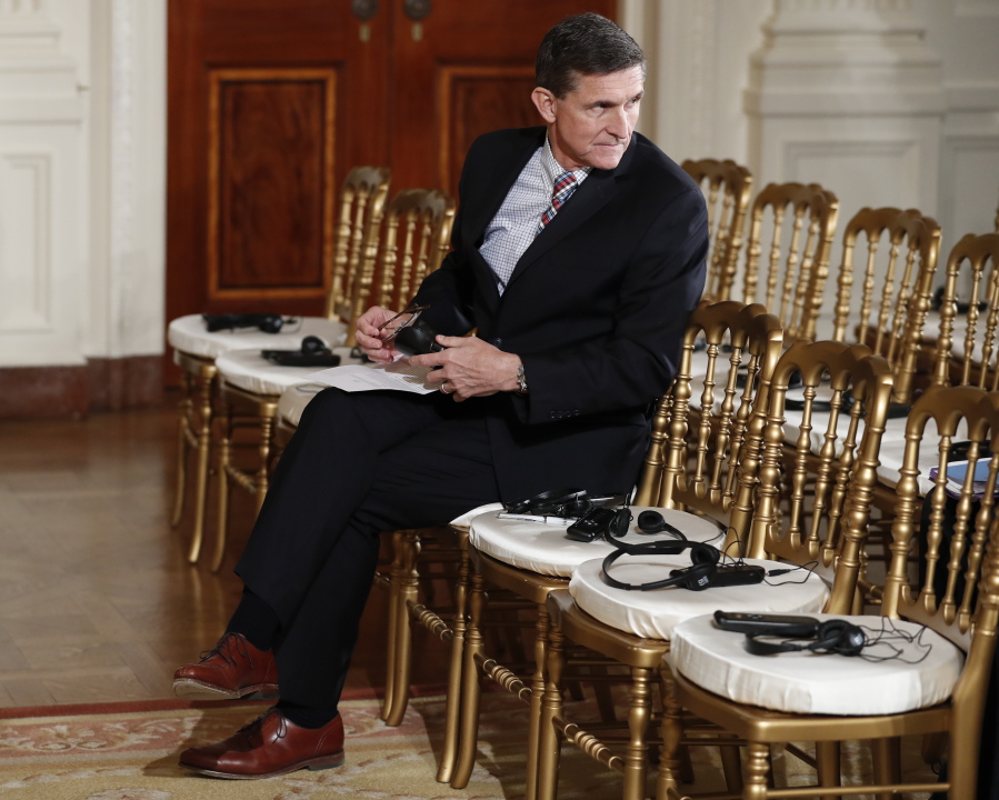 In this photo taken Feb. 10, 2017, then-National Security Adviser Michael Flynn sits in the front row in the East Room of the White House, in Washington. Attorneys for Flynn say that a daily "escalating public frenzy against him" and the Justice Department's appointment of a special counsel has created a legally dangerous environment for him to cooperate with a Senate investigation. That's according to a letter obtained by The Associated Press sent Monday by Flynn's legal team to the Senate Intelligence committee. It lays out the case for Flynn, the former national security adviser, to invoke his right against self-incrimination.