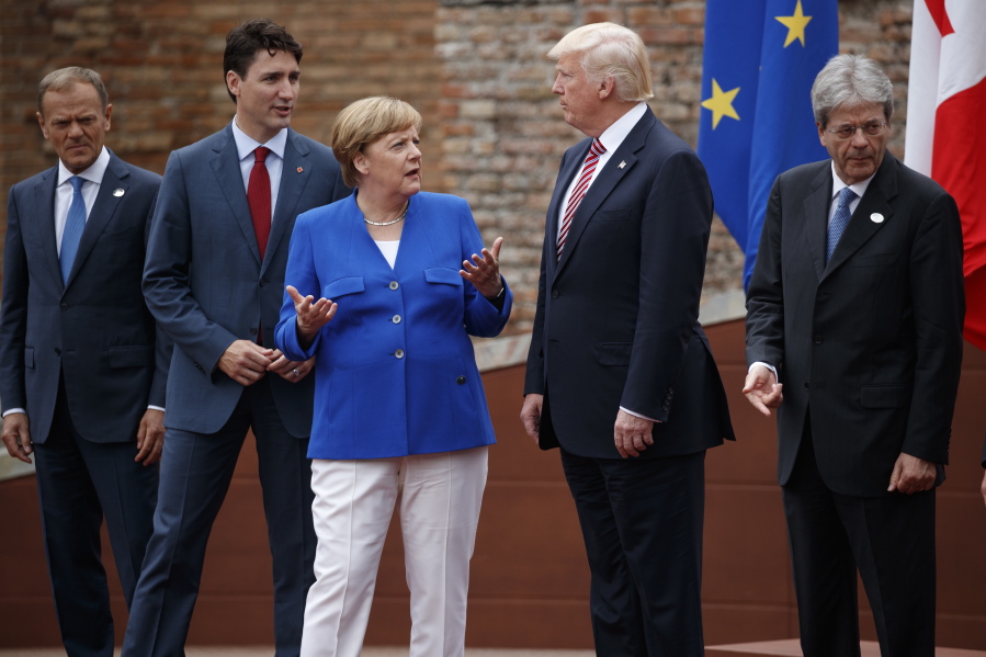 G7 leaders, from left, President of the European Commission Jean-Claude Junker, Canadian Prime Minister Justin Trudeau, German Chancellor Angela Merkel, President Donald Trump, and Italian Prime Minister Paolo Gentiloni get ready to take a portrait at Ancient Greek Theater of Taormina, on Friday in Taormina, Italy.