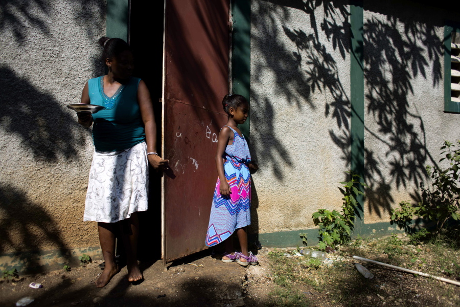 Marie-Ange Haitis, 40, stands with her daughter, Samantha, at their home in Leogane, Haiti. Haitis says she met a Sri Lankan commander in December 2006 and he soon began making nighttime visits to her house. In 2016, Sri Lankan and U.N. officials said that a onetime payment of $45,243 had been made for Haitis’ daughter. The United Nations said Sri Lanka accepted the paternity claim without proof of DNA and the commander was dismissed from service. But such payments are rare.
