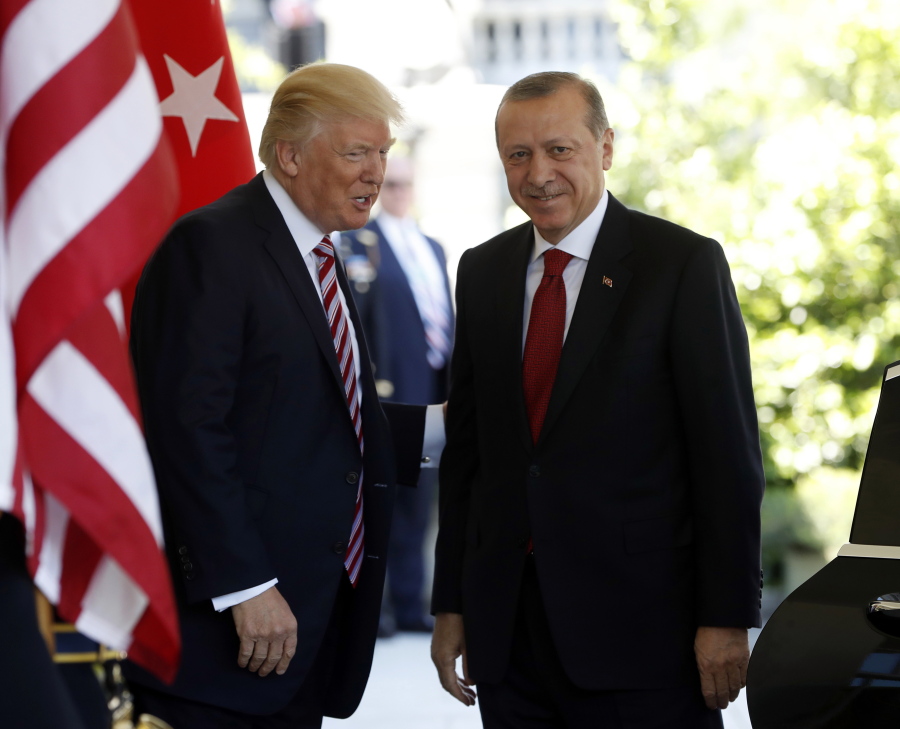 In this May 16, 2017, photo, President Donald Trump welcomes Turkish President Recep Tayyip Erdogan to the White House in Washington. The Trump administration faced growing calls Thursday for a forceful response to violence by Turkish presidential guards on American soil, who were briefly detained this week but then set free. The unseemly incident added to U.S.-Turkish tensions that are being compounded by a growing spat over U.S. war strategy against the Islamic State group in Syria.