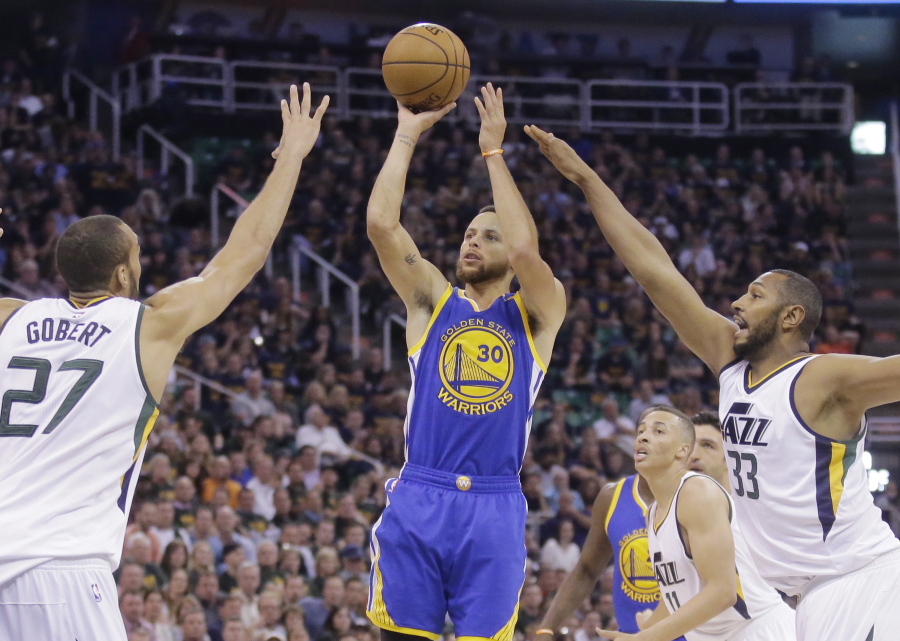 Golden State Warriors guard Stephen Curry (30) shoots as Utah Jazz&#039;s Rudy Gobert (27) and Boris Diaw (33) defend in the first half during Game 4 of the NBA basketball second-round playoff series, Monday, May 8, 2017, in Salt Lake City.