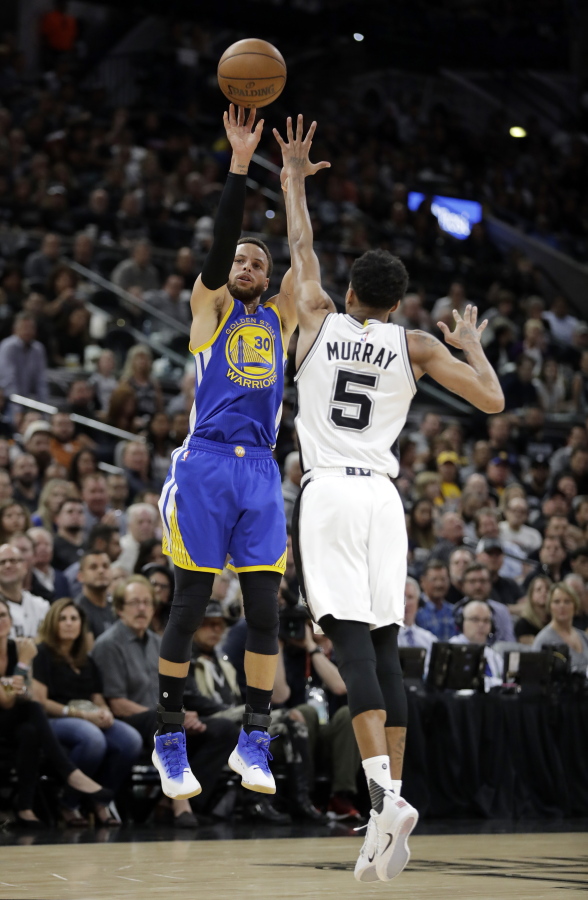 Golden State Warriors guard Stephen Curry (30) takes a shot over San Antonio Spurs' Dejounte Murray (5) during the first half in Game 4 of the NBA basketball Western Conference finals, Monday, May 22, 2017, in San Antonio.