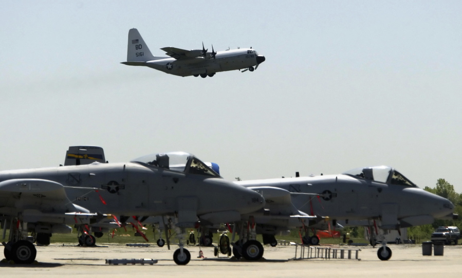 A-10s from the 111th Fighter Wing are seen in the foreground as a U.S. Navy C-130 takes off from N.A.S. J.R.B. Willow Grove in Willow Grove Pa.