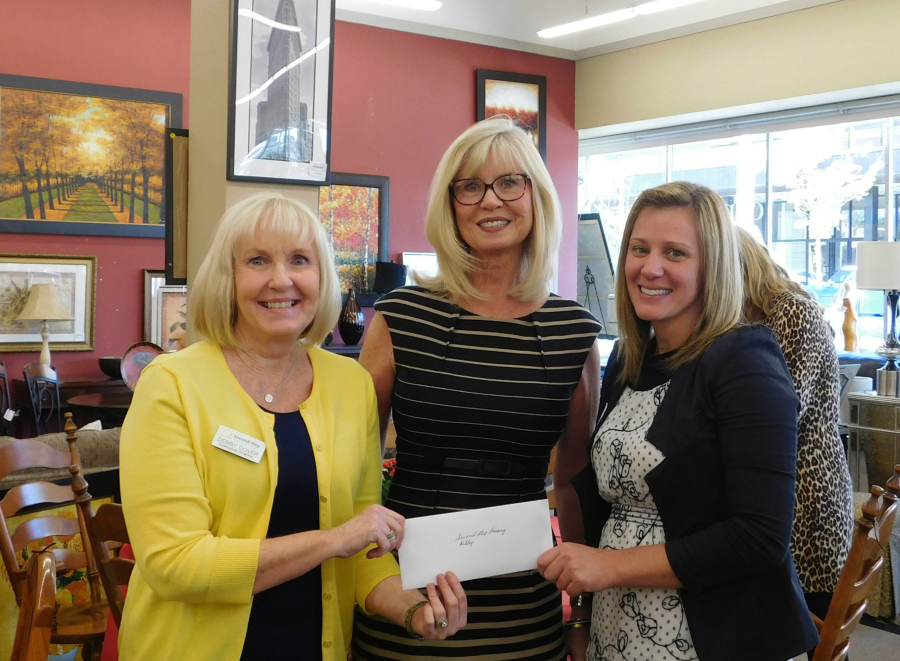 Debby Dover, from left, Lind Glover and Amy Platt smile in spring 2016 after Second Step Housing was awarded money from Gifts For Our Community.
