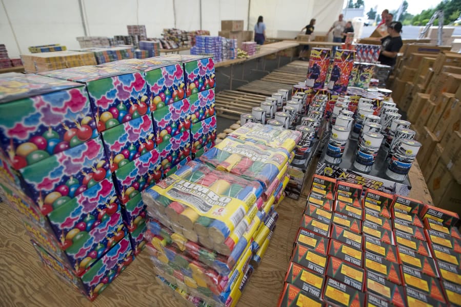 Workers stock a fireworks stand off Northeast Andresen Road prior to its opening in 2011. Fireworks will sold again in most of the county this year, but Vancouver has banned their sale and use.
