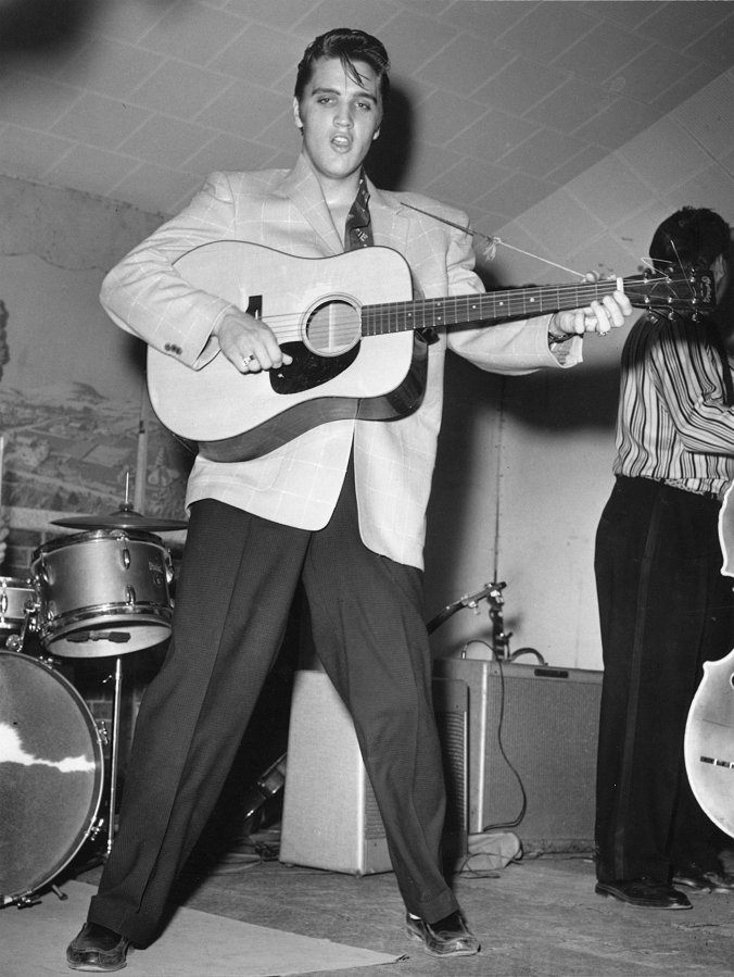 Elvis Presley plays guitar during a concert in Fort Worth, Texas, early in his career.