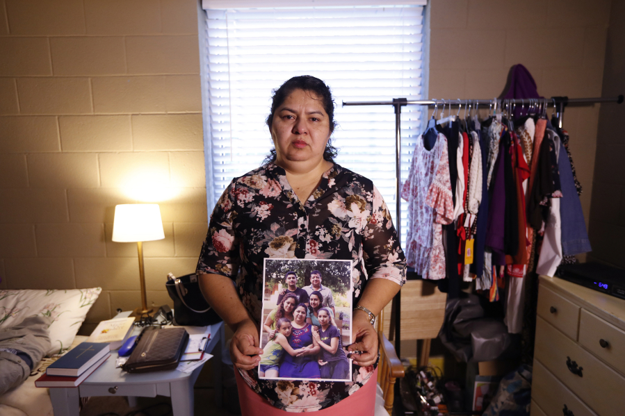 Juana Luz Tobar Ortega holds a photo of her family at St. Barnabas Episcopal Church in Greensboro, N.C. Ortega, who is scheduled for deportation, is taking sanctuary in the Greensboro church.