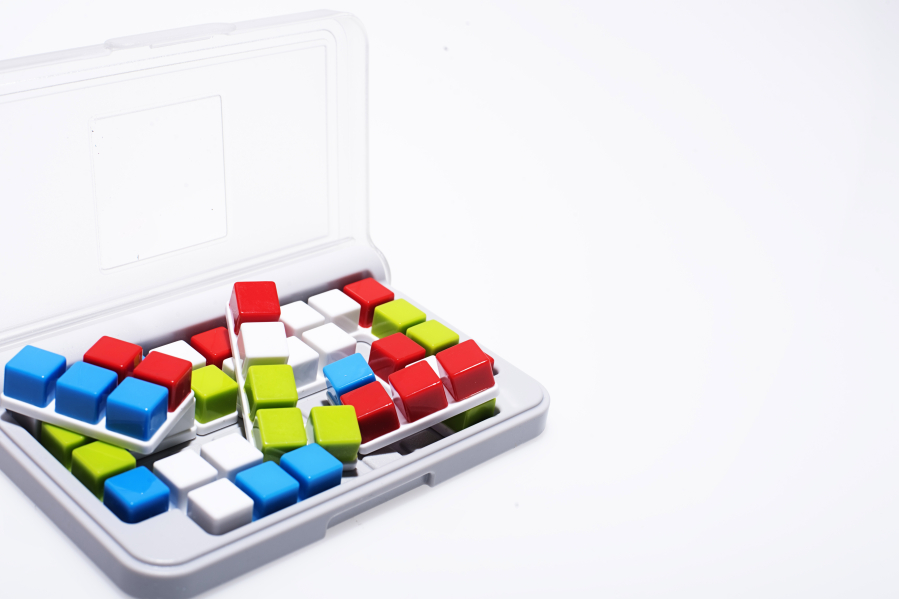 IQ Focus (SmartGames, $9.99) is a new one-person puzzle game with colored blocks that fit in 120 patterns on a grid.