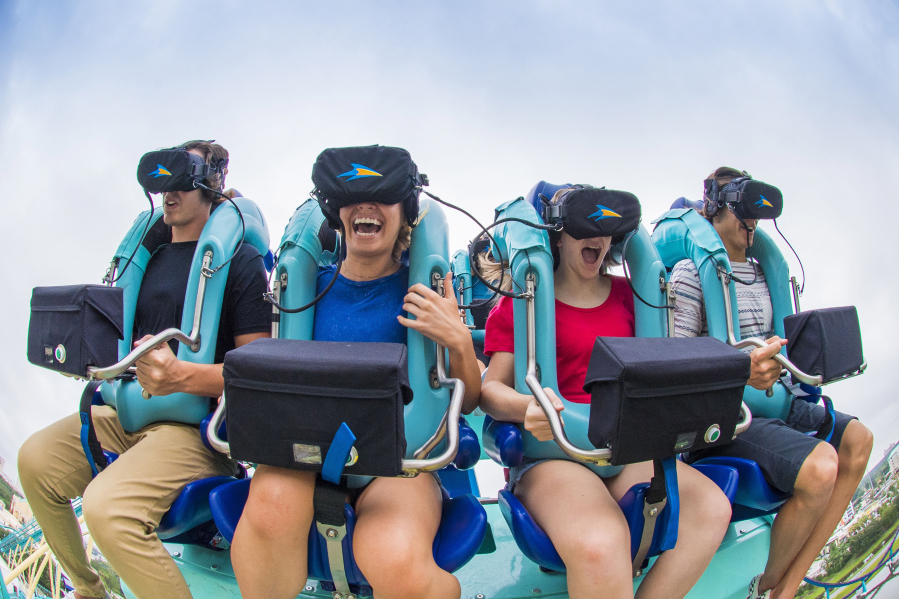 As Kraken speeds through a loop and turns upside down, its riders wearing virtual reality headsets are experiencing an undersea adventure.