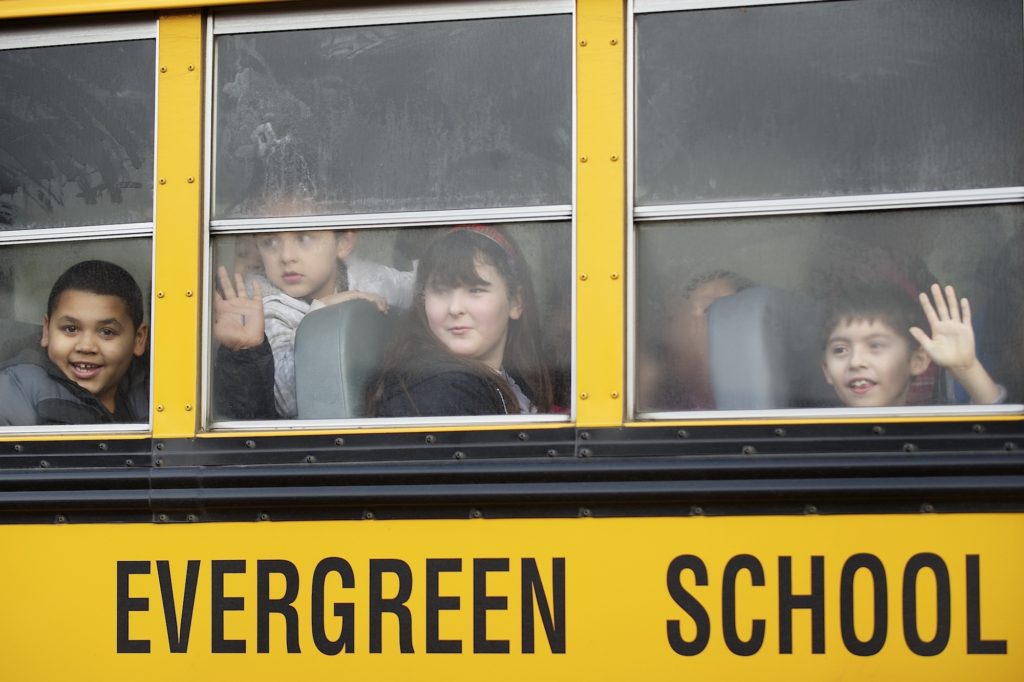 Third grade students from Crestline Elementary School get a first look at Riverview Elementary School through foggy windows of a school bus Thursday February 7, 2013 in Vancouver, Washington. Riverview Elementary welcomed 93 Crestline third-graders, teachers and administrators after their school burned down.