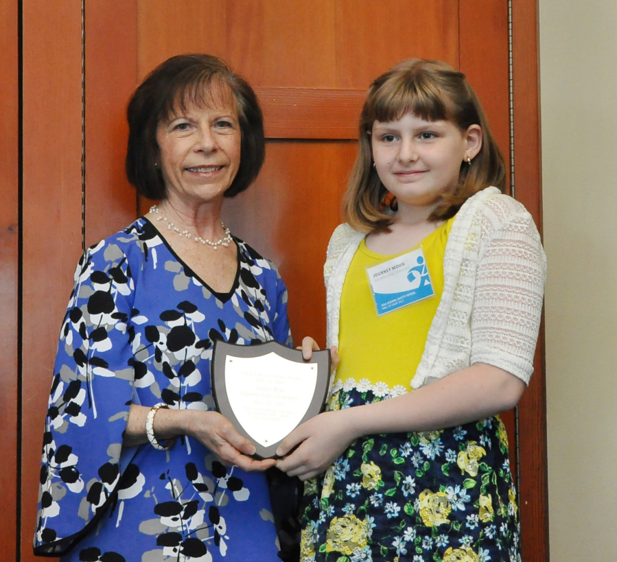 Bennington: Columbia Valley Elementary School fifth-grader Journey Mohn, left, with Janet Ray, of AAA Washington, receiving her award inducting her into the AAA School Safety Patrol Hall of Fame.