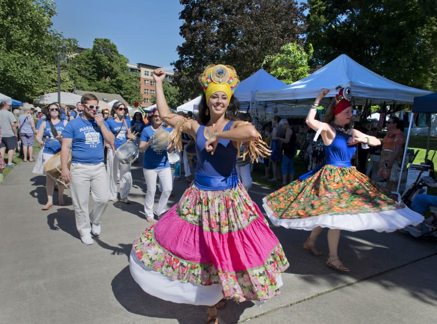 Deborah Galvan, center, and the MARACATUpdx Brazilian marching band leads the Processions of the Species parade at the Recycled Arts Festival in Esther Short Park on Sunday.