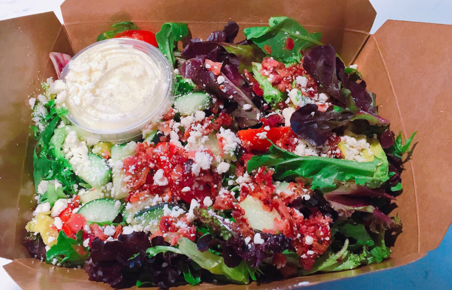 Foode Cafe & Catering offers up multiple salads including the Cucumber Feta BLT salad with ranch and Avocado Caprese salad with a balsamic glaze.