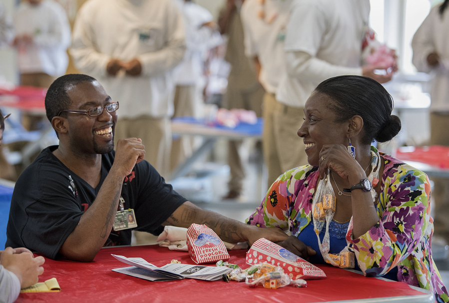 Christopher Randon, left, an inmate at Larch Corrections Center, shares a laugh with his mom, Naomi Randon of Tacoma, during its Juneteenth celebration. The prison hosted the event Saturday with food, guest speakers and poetry.