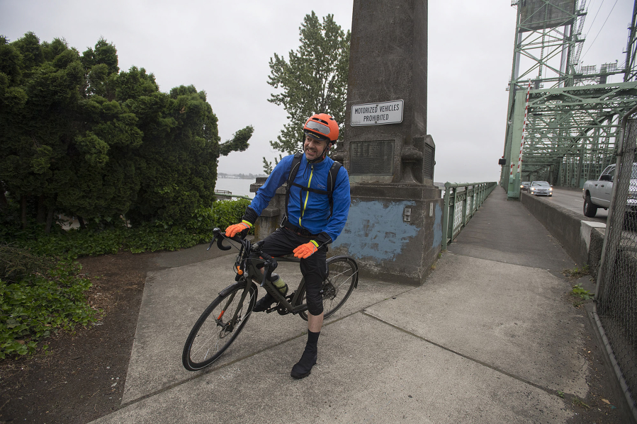 Frank Dick makes his way across the Interstate 5 Bridge with northbound traffic on his way to work in Vancouver. Dick bikes 12 miles each way from his home in Southeast Portland.