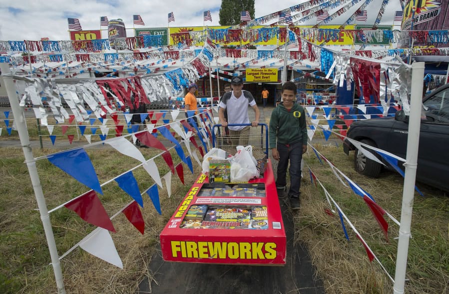 Brendon Abbott, 17, center, and Rashad Dixon, 11, push a cart full of fireworks from TNT Fireworks on the opening day of sales in unincorporated Clark County. Each Fourth of July, their household participates in a community celebration. They’re going to provide the grand finale to this year’s celebration.