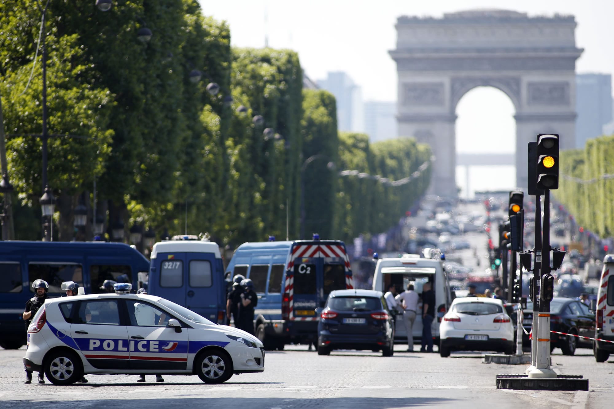 Police forces secure the area on the Champs Elysées in Paris, Monday, June 19, 2017. A driver rammed his car into a police vehicle in the Champs-Elysees shopping district Monday, prompting a fiery explosion, and was likely killed in the incident, authorities said. France's anti-terrorism prosecutor opened an investigation.