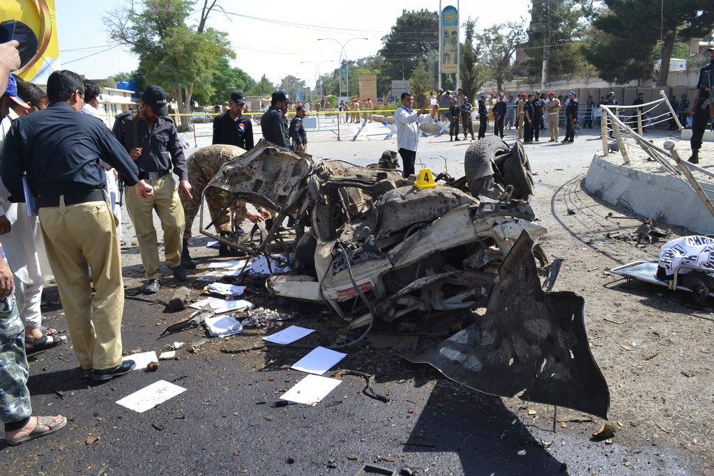 Pakistani police officers examine the site of an explosion in Quetta, Pakistan, Friday, June 23, 2017. A powerful bomb went off near the office of the provincial police chief in southwest Pakistan on Friday, causing casualties, police said.