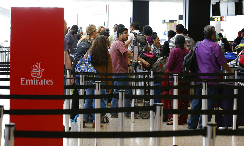 Travelers wait in line near an Emirates ticket counter at the Seattle-Tacoma International Airport, Monday, June 26, 2017, in Seattle. The U.S. Supreme Court said Monday that President Donald Trump's travel ban on visitors from Iran, Libya, Somalia, Sudan, Syria and Yemen can be enforced if those visitors lack a "credible claim of a bona fide relationship with a person or entity in the United States," and that justices will hear full arguments in October 2017. (AP Photo/Ted S.