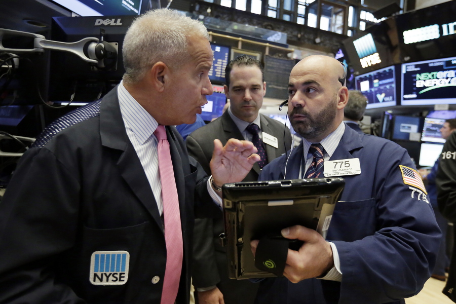 New York Stock Exchange floor official Rudy Mass, left, talks with trader Fred DeMarco, right, on the floor of the NYSE, Friday, June 23, 2017. U.S. stock indexes inched higher Friday as energy companies clawed back some of their sharp losses from earlier in the week.