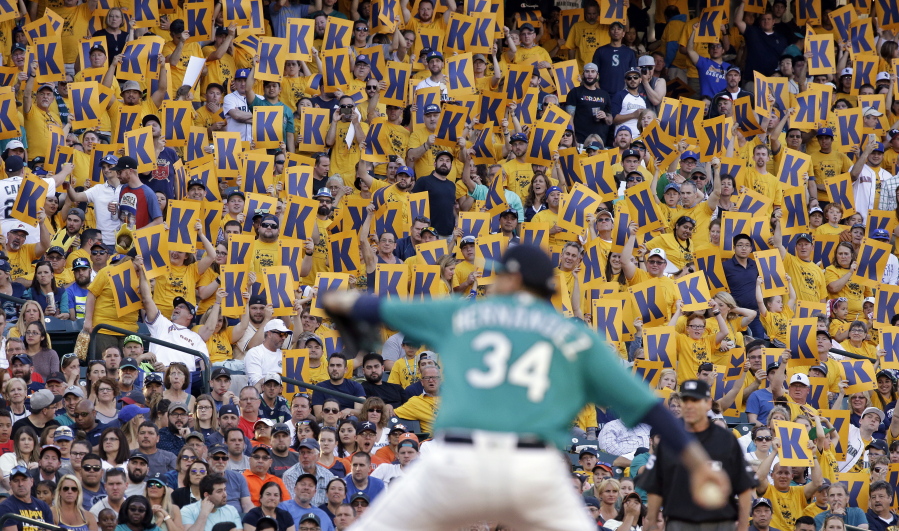Fans hold "K" cards, designating a strikeout, as Seattle Mariners starting pitcher Felix Hernandez throws against the Houston Astros during the second inning of a baseball game Friday, June 23, 2017, in Seattle.