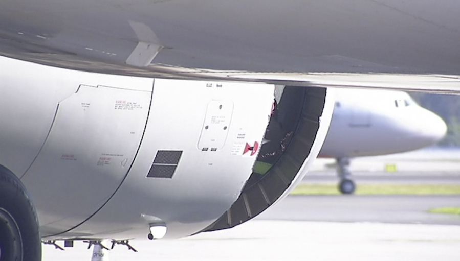 In this image made from video, a hole is seen in the engine of China Eastern airlines Flight 736 after it landed in Sydney, Australia, on Monday. China Eastern said the crew on Flight 736 noticed damage to the air inlet on the left engine after takeoff Sunday evening and the captain decided to return.