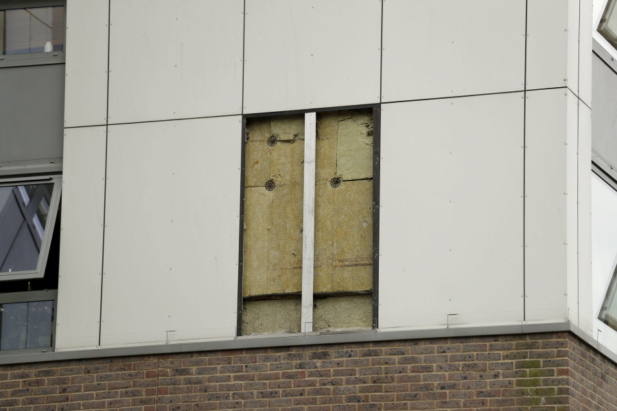 A view of part of the Burnham residential tower on the Chalcots Estate showing the bottom section of the building after cladding was removed, in the borough of Camden, north London, Thursday. Tests so far have found that at least three high-rise apartment buildings in the U.K. have flammable external panels like the ones believed to have contributed to a fire that killed 79 people in London, Britain’s government said Thursday. The local council in Camden, a borough of London, removed cladding from one of its buildings for further testing after tests they commissioned showed some of their panels were of the flammable variety — and not the ones they ordered.﻿ It was unclear whether the Camden example was one of the three mentioned by the government.