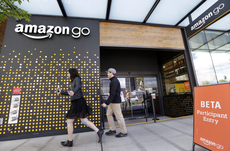People walk past an Amazon Go store, open only to Amazon employees, in Seattle in April.